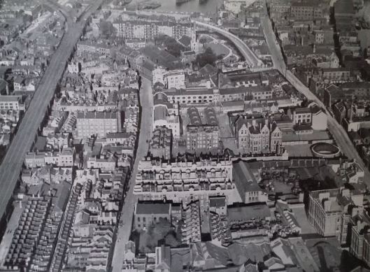 Plate II 'Defects of Present-Day London: The air view shows the intermixed development with houses close alongside railway viaducts, schools adjoining industry, tenements mixed with wharves and warehouses, an absence of private gardens and negligible public open space'