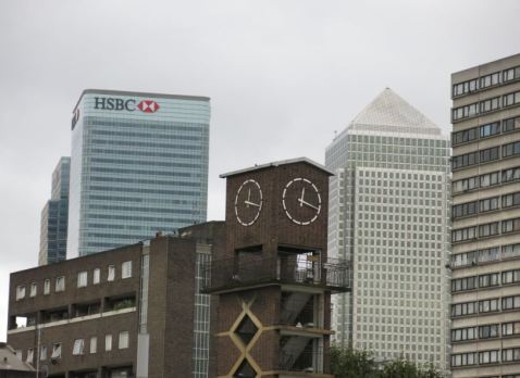 Frederick Gibberd's clock tower in Chrisp Street market with its backdrop Canary Wharf