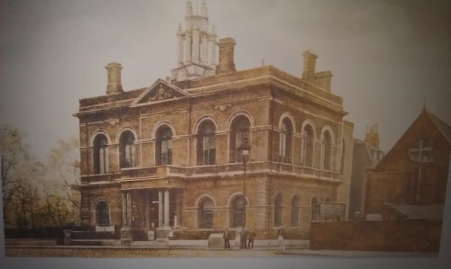 A tinted photograph of the town hall in its early heyday